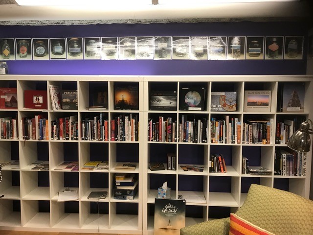 Shelves, that look like cubbies, with books.