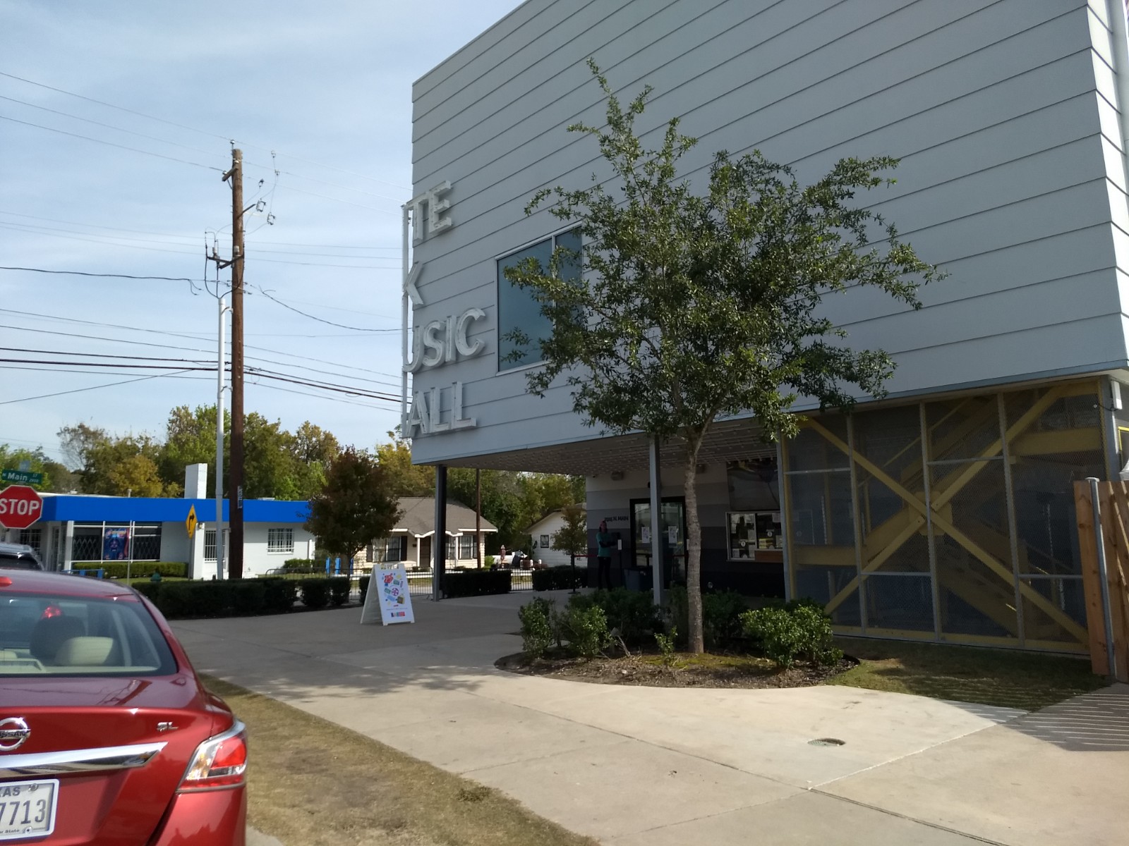 Exterior view of building on street corner, partial text of building name shown.