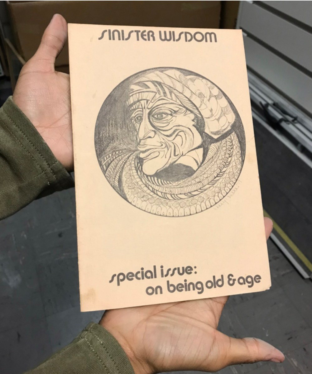 Issue of Sinister Wisdom being held, title at top, illustration of an old Black Woman, sub title "special issue: on being old & age"