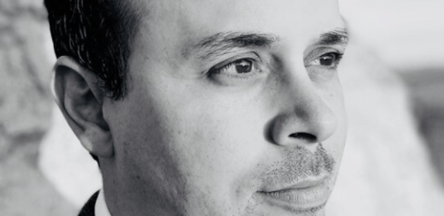 Close profiles of a man in a suit jacket and shirt